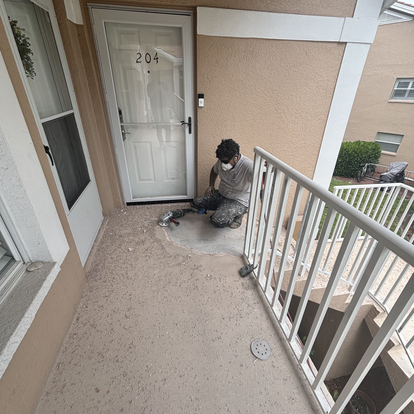MORA crew member restoring a concrete walkway landing at Bermuda Gardens