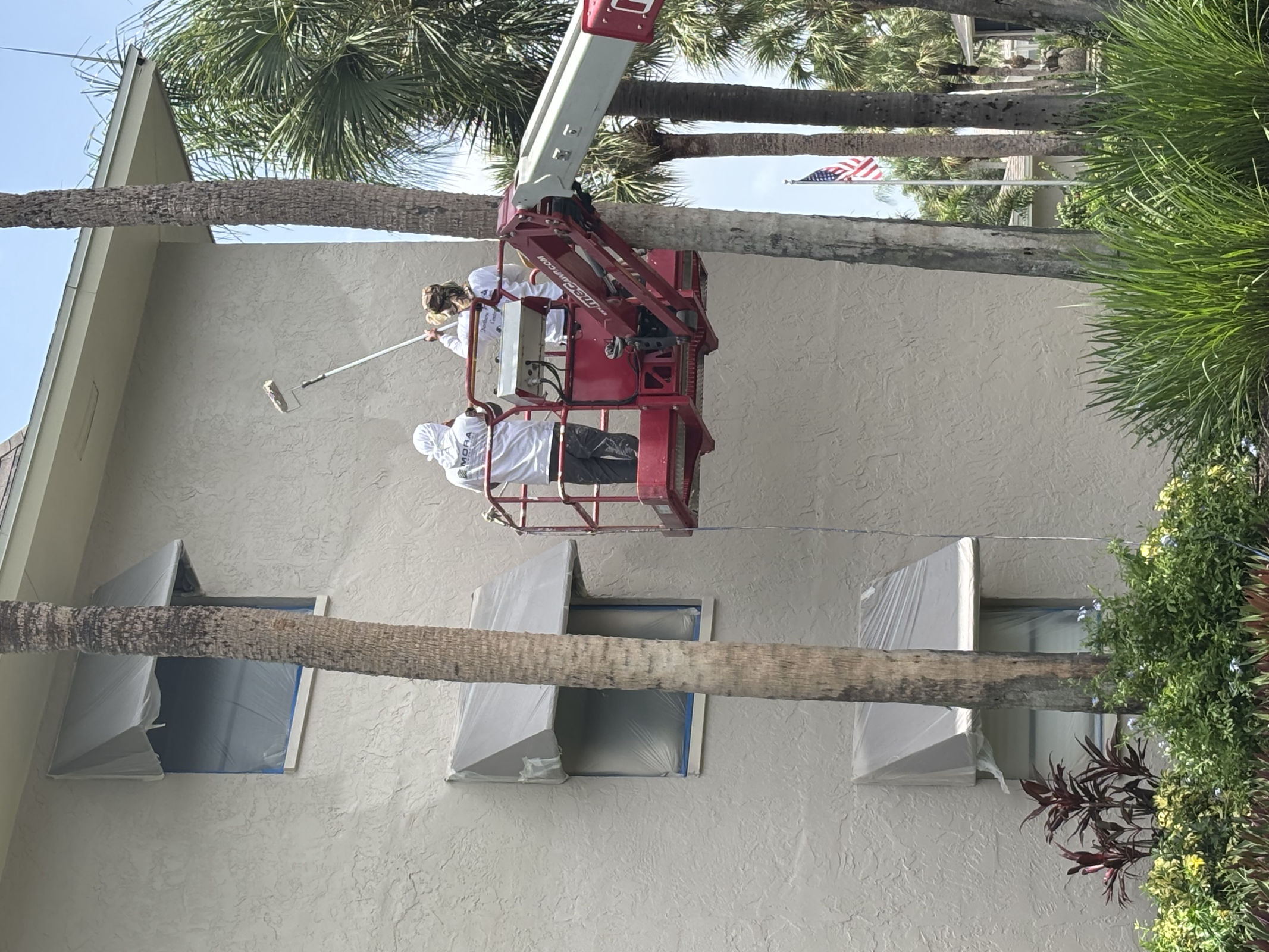 MORA crew painting from a boom lift at Imperial Gardens condominiums