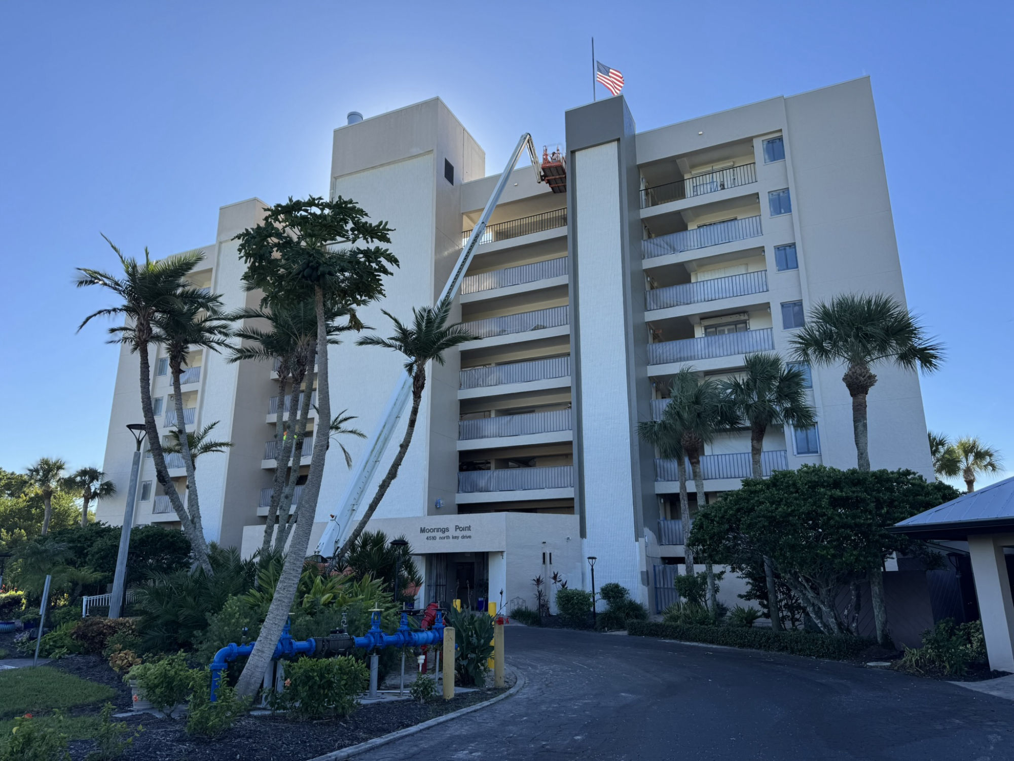 Moorings Point condominium tower in Fort Myers with MORA boom lift during exterior repaint