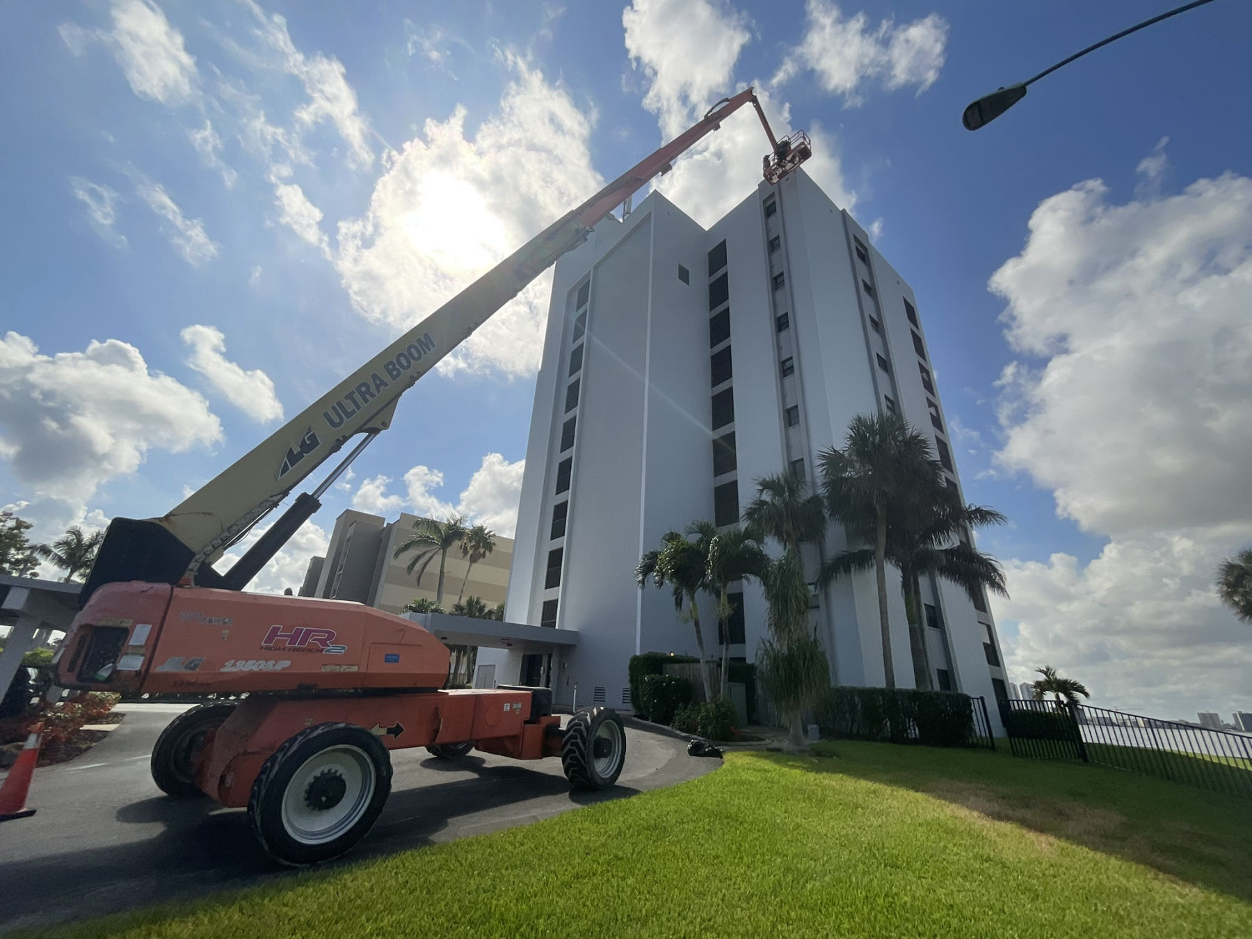 Sunset North tower, Fort Myers FL — fresh coating system applied by MORA with ultra boom lift