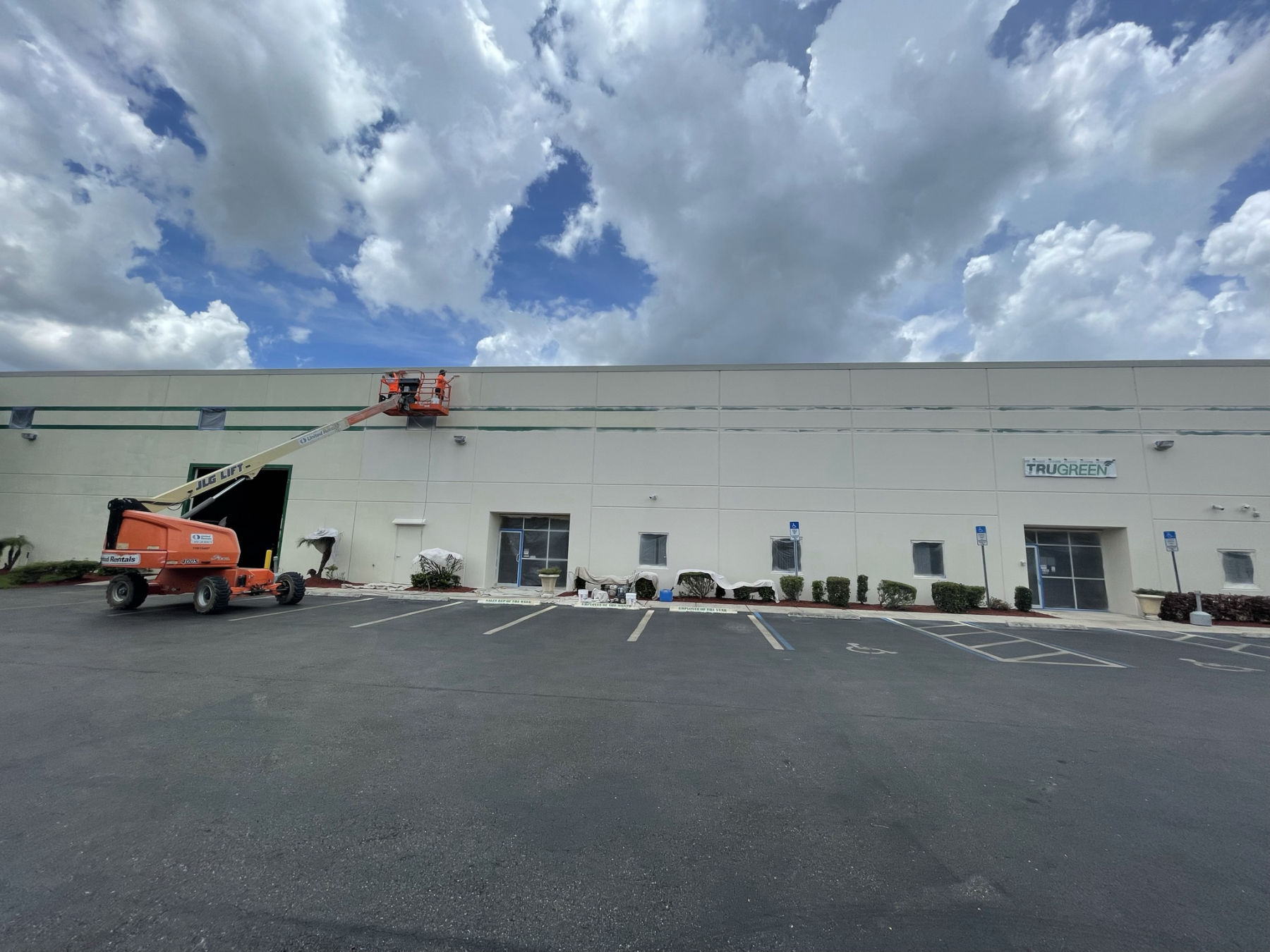 MORA crew on a boom lift repainting the TruGreen commercial building