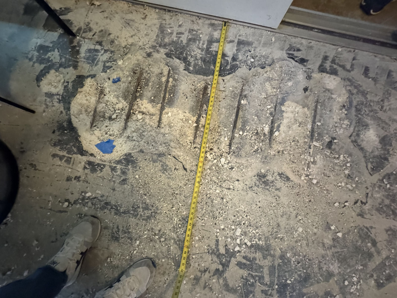 Spalled concrete with exposed rebar being measured and mapped during a MORA structural survey at Vanderbilt Towers, Naples