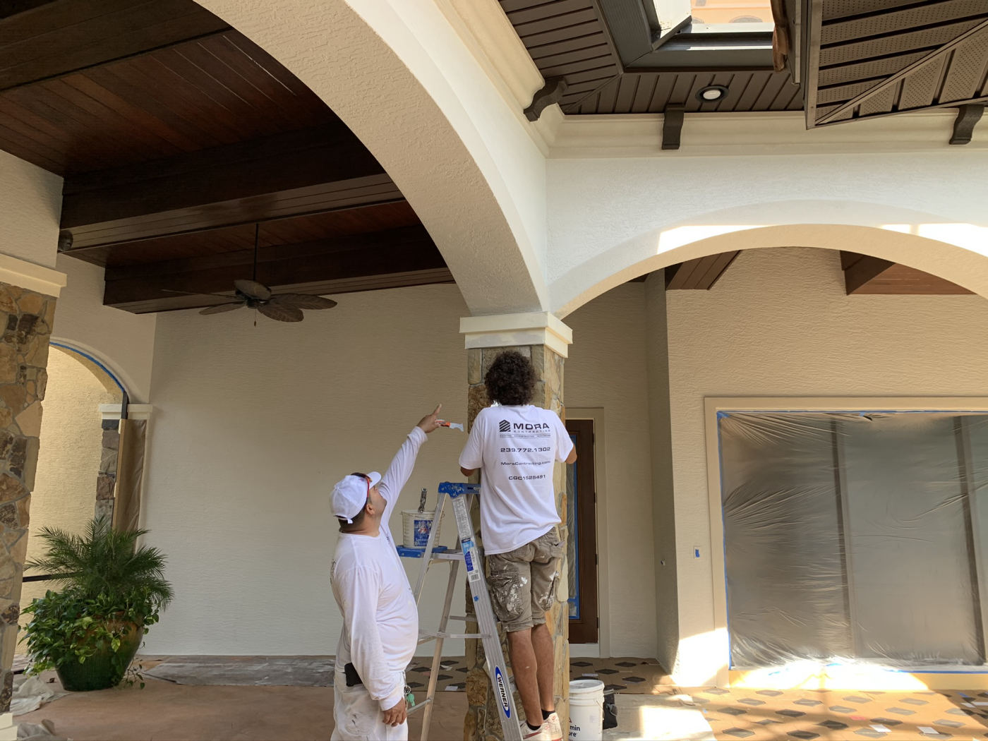 MORA painters cutting in the loggia arches of a luxury Southwest Florida estate